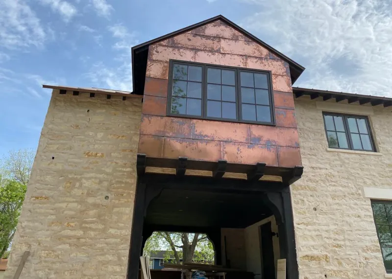 Copper metal panel facade on a stone building for Skylight Installation in Gallatin